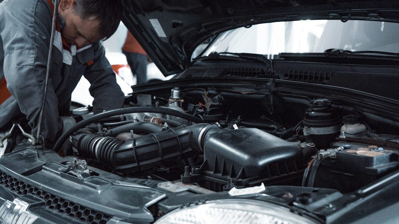 A mechanic carrying out repair work on a vehicle