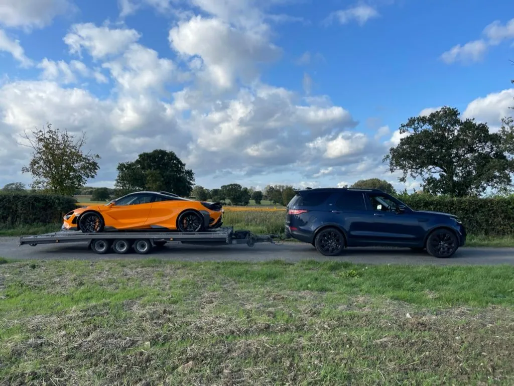 Orange McLaren supercar loaded on a TD Vehicle Solutions transporter