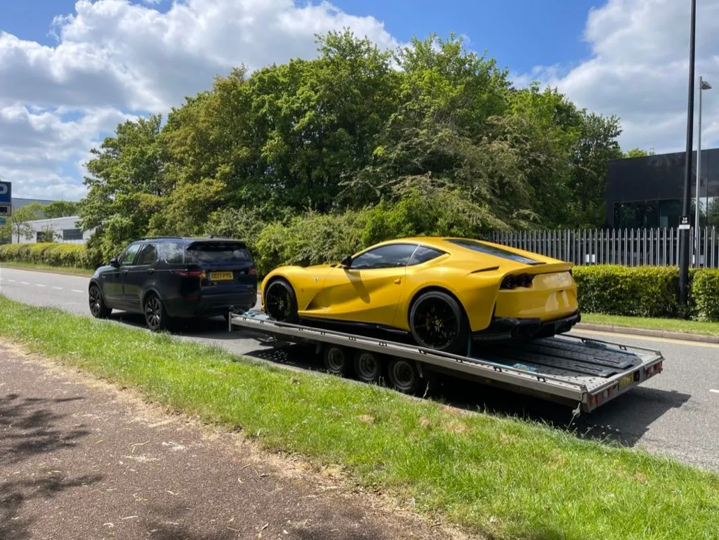 Yellow Ferrari loaded on a TD transporter