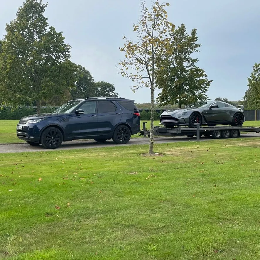 A TD Vehicle Solutions transporter carrying a customer vehicle